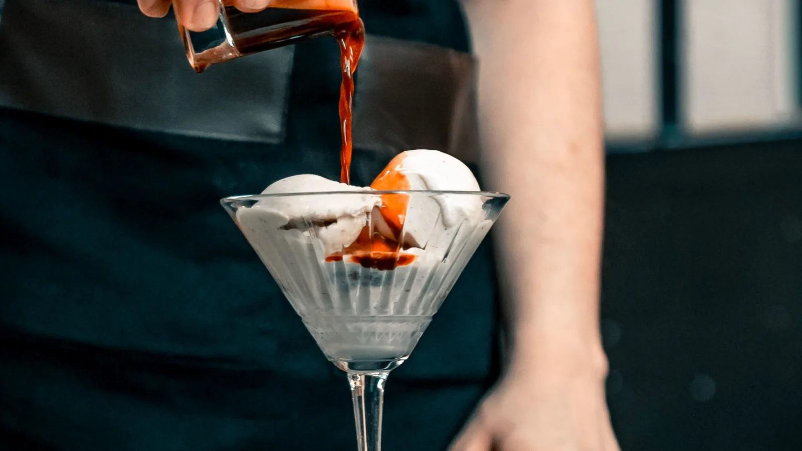Photo by Duran Ekiz on Pexels Coffee-colored liquid poured over two pale ice-cream scoops in a glass