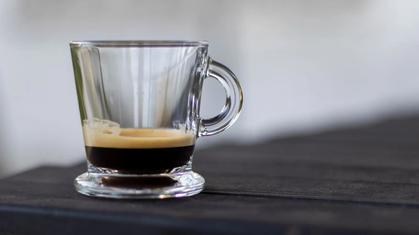 Photo by Anselmo Machado on Pexels A small clear cup holding a dark espresso with crema on a table