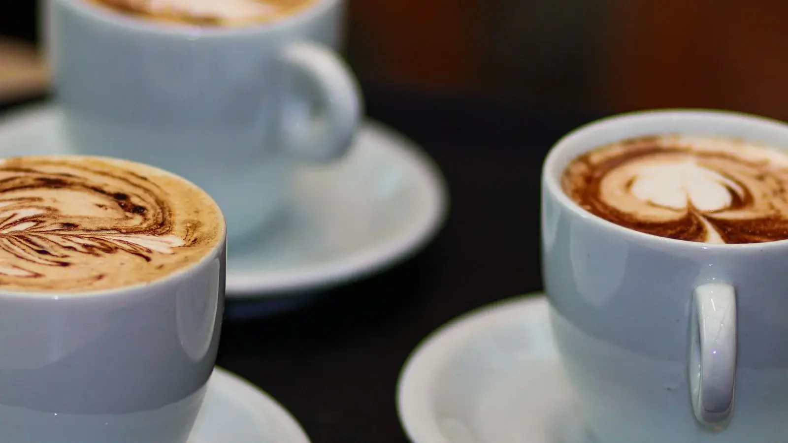 Photo by Luana Ribeiro on Pexels Three milk coffees with latte art in white cups