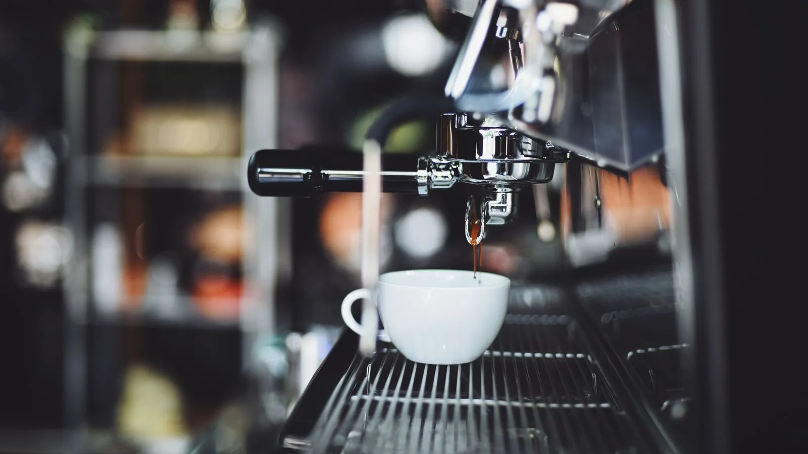 Espresso pouring into a white cup