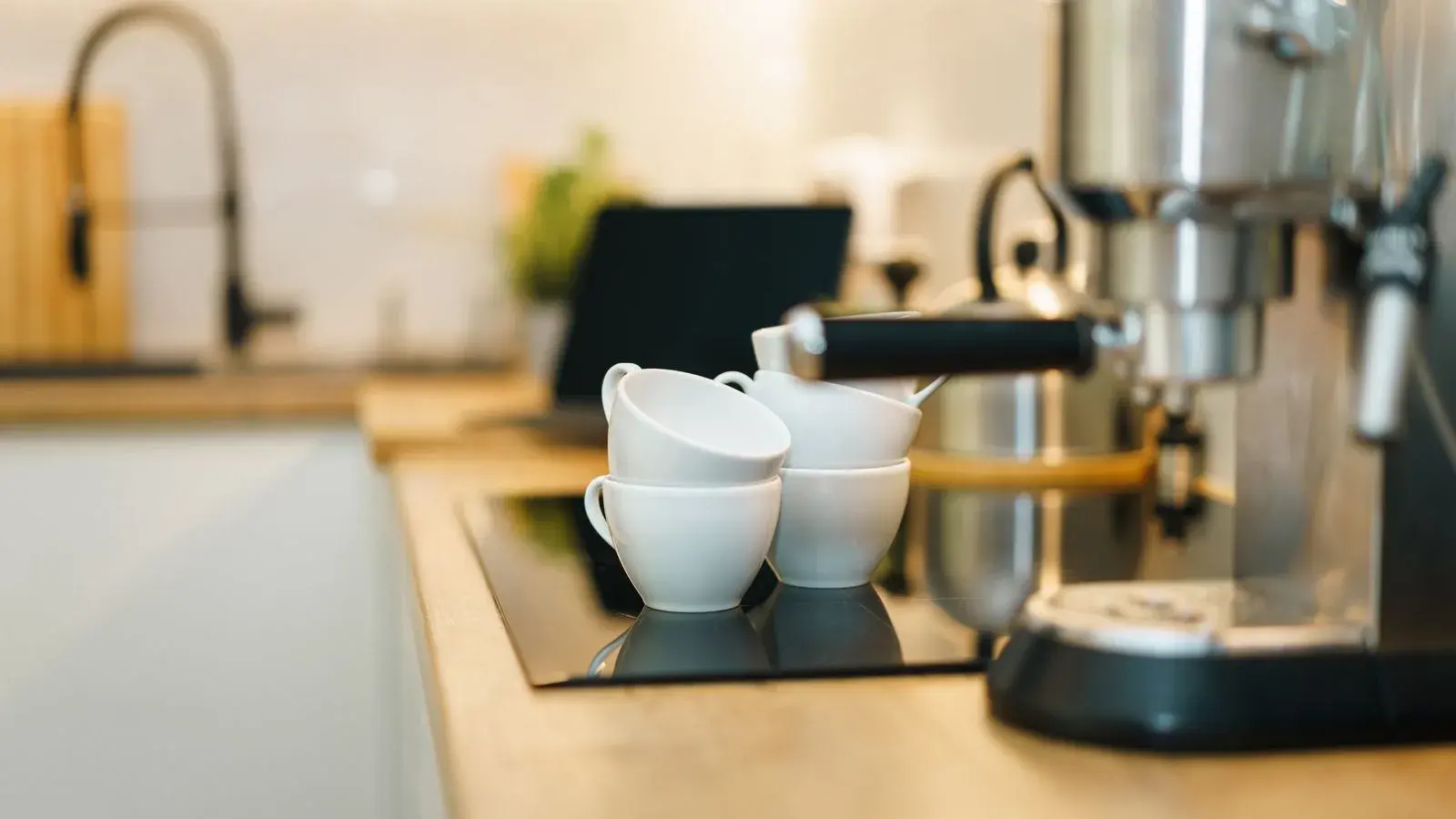 Photo by Jakub Zerdzicki on Pexels An espresso machine and cups on a kitchen counter