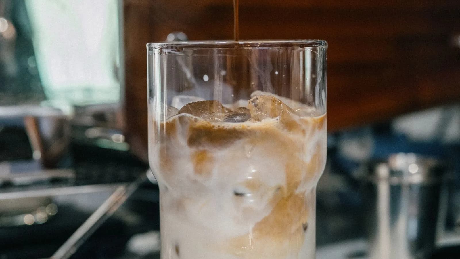 Photo by Nguyen Duc Toan on Pexels Ice and coffee-colored liquid mixing with milk in a clear glass