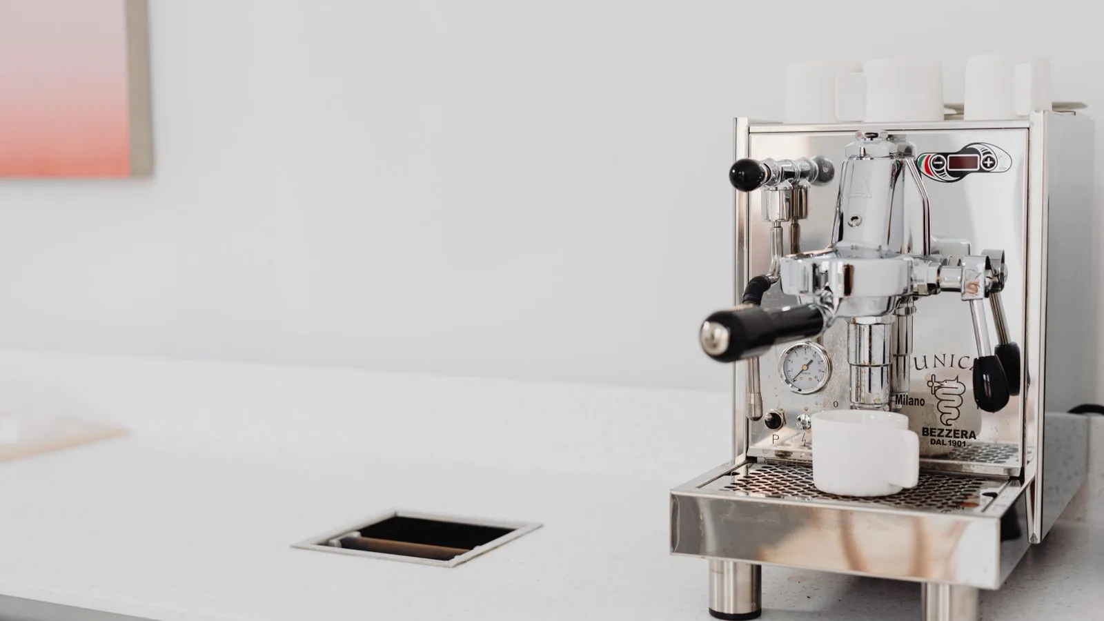 A stainless steel espresso machine on a kitchen counter