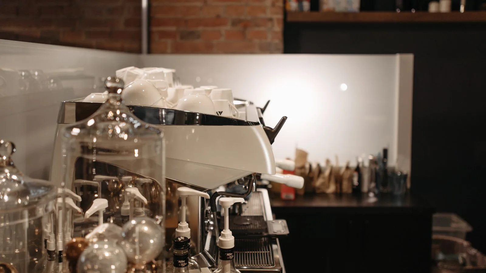 An espresso machine and cups in a coffee shop