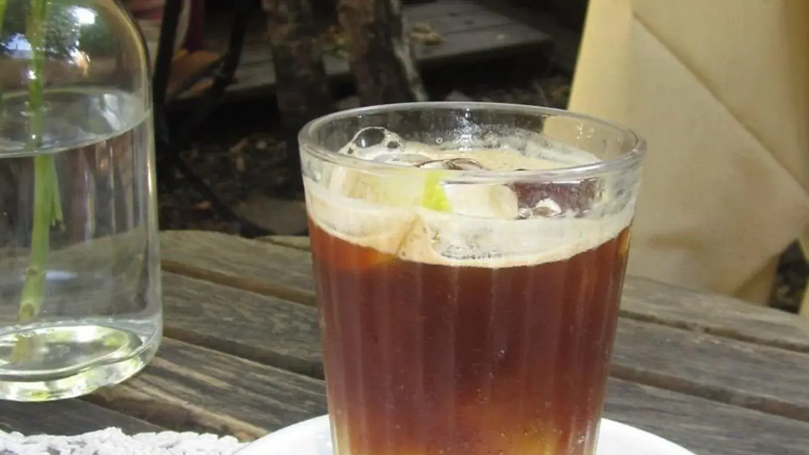 Photo by Floriansrz on Wikimedia Commons (CC0 1.0) A layered dark coffee drink over ice in a clear glass on a saucer